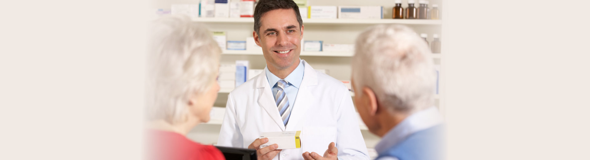 pharmacist smiling at senior couple